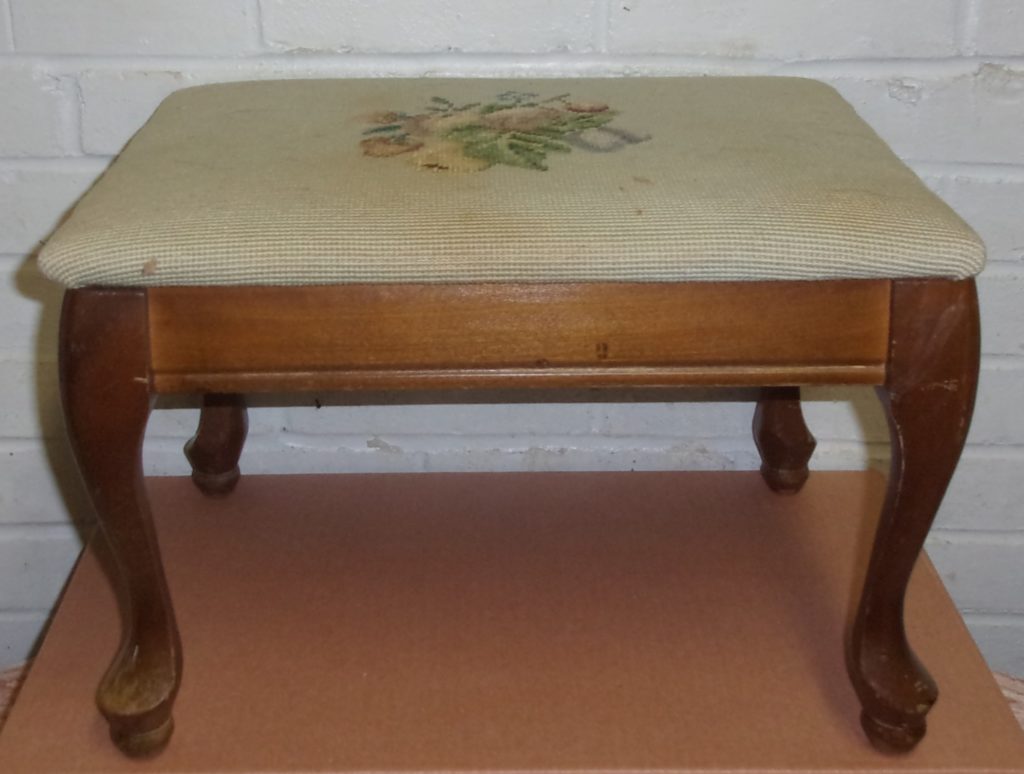 old wooden footstool with tapestry cloth on top ready for furniture makeover